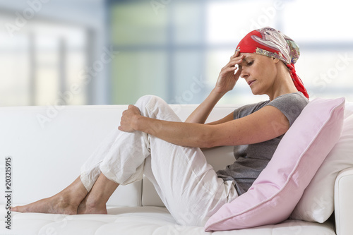 Photos Exhausted woman after chemotherapy resting at home lying on couch
