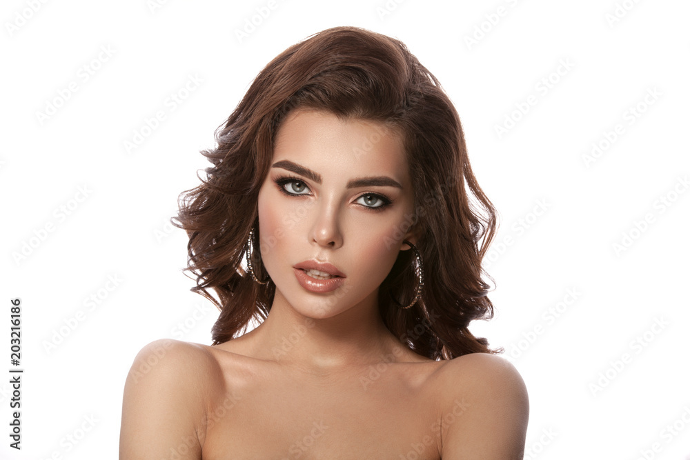 Beauty portrait of a young girl with natural make-up and natural lip color. Hairstyle curls, chestnut hair color. White isolated background. Beauty portrait of a young girl with natural make-up and natural lip color. Hairstyle curls, chestnut hair color. White isolated background.