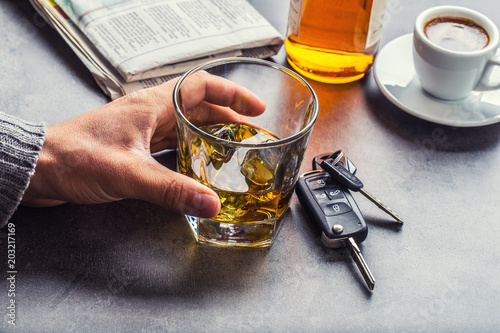 Glass of alcohol hand man the keys to the car and irresponsible driver