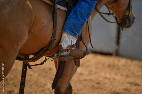 The cowboy leg in jeans and boot 