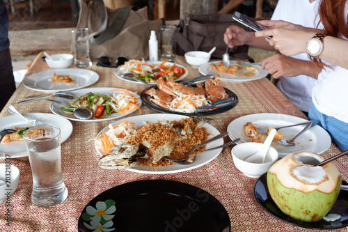 Shrimp, fried snapper fish with garlic, fried oyster shell Black Pepper and antipasto appetizer sitting on table in fine dining restaurant.