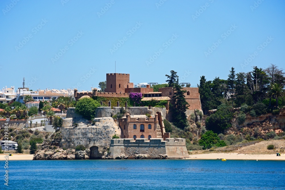 View of a fort above the beach along the Arade River, Portimao, Algarve, Portugal.