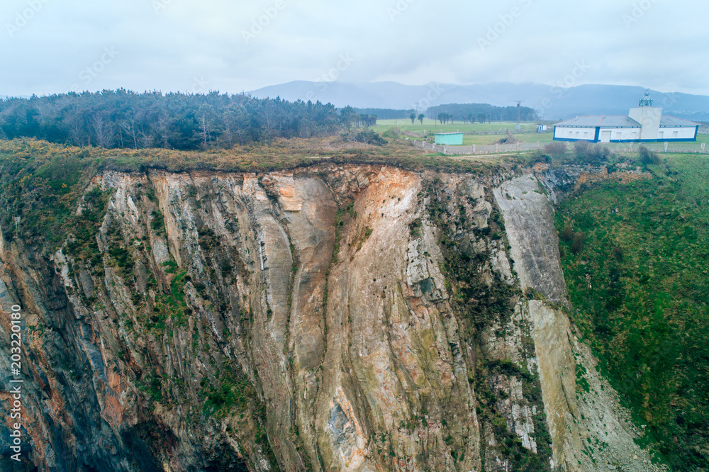 Aerial view of a lighthouse on a cliff in Asturias, north of Spain