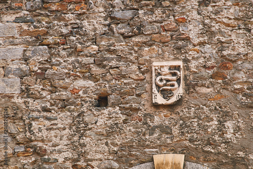 Ancient coat of arms of Swiss city of Bellinzona depicting an erect serpent on the old town wall