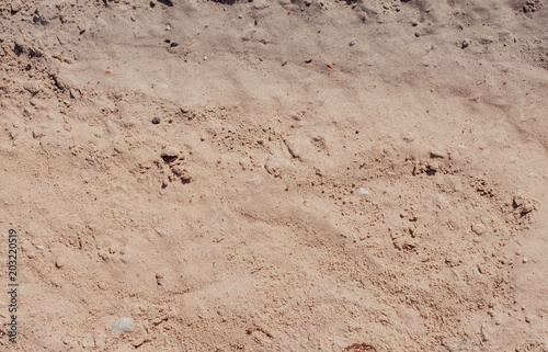 Wave of the sea on the sand beach, summer sand beach background with footprint