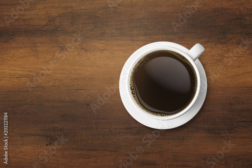 white coffee cup and hot espresso coffee on wooden table. top view