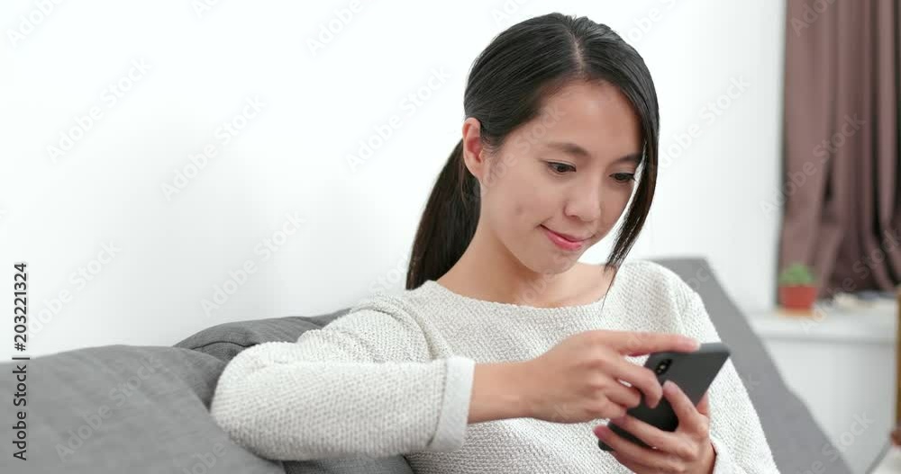 Woman using mobile phone at home Woman using mobile phone at home