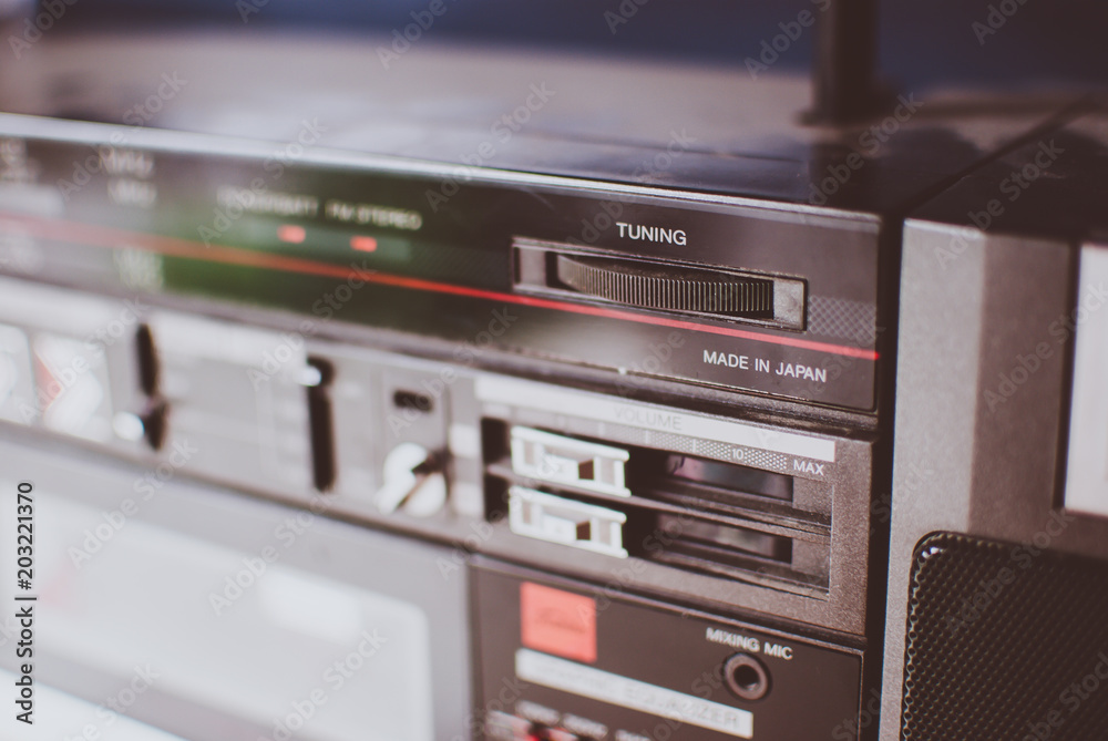 Obraz premium Retro dusty boombox (tape recorder) on a shelf in a garage