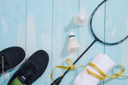 Top view of sport equipments, clock, tape measure, shoes, water bottle, towel, badminton racket and shuttlecock, Healthy lifestyle and fitness concept