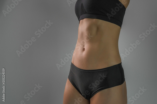 Portrait of a female figure, tightened sexy sports belly