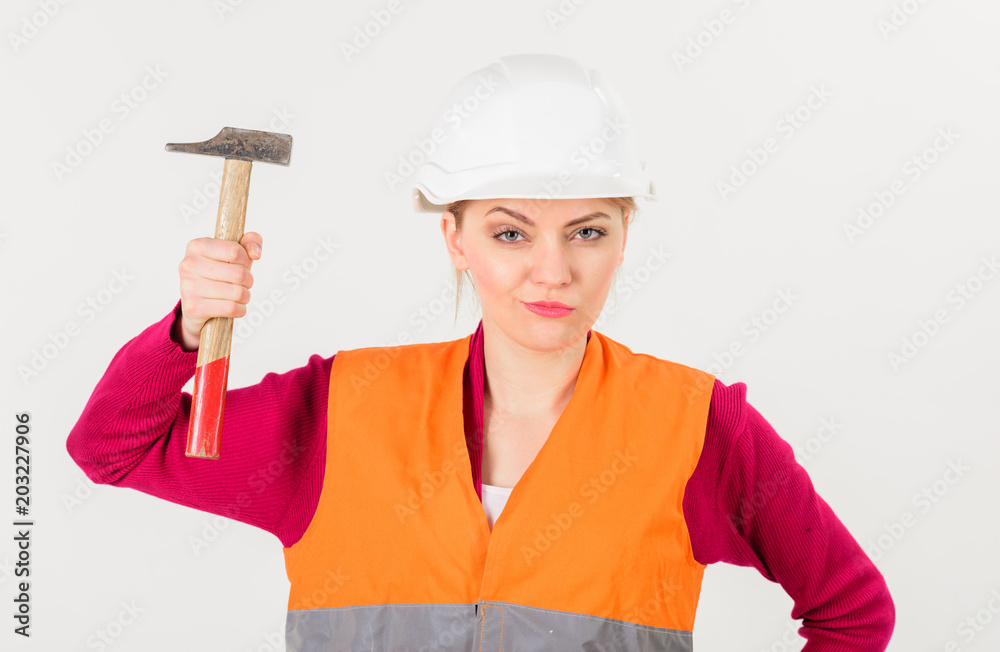 Feminism concept. Girl in helmet or hard hat raise hammer. Feminism concept. Girl in helmet or hard hat raise hammer.