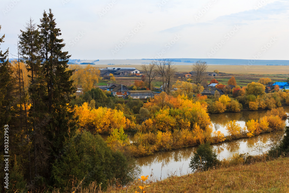Rural fall landscape with the lake and yellow trees