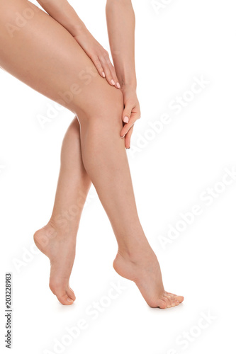 Young woman showing smooth silky skin after epilation on white background