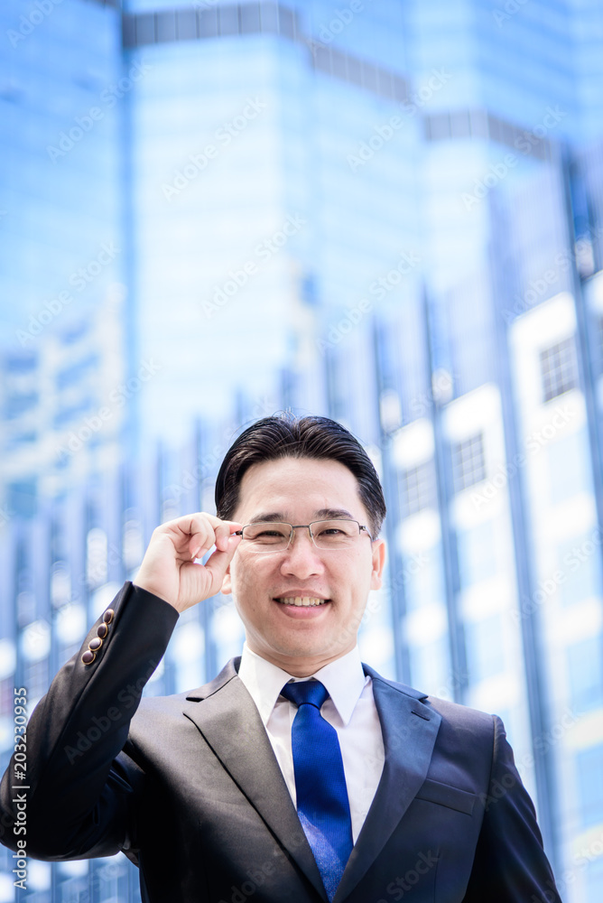 The asian businessman has thinking of vision with building and city background. The asian businessman has thinking of vision with building and city background.