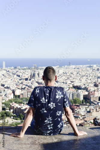 Photography young man with Barcelona, Spain, below him