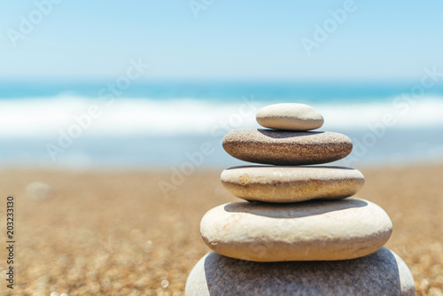 Stack of zen stones on the beach near sea