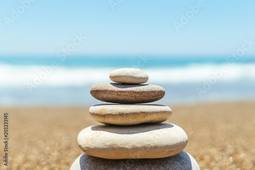 Stack of zen stones on the beach near sea