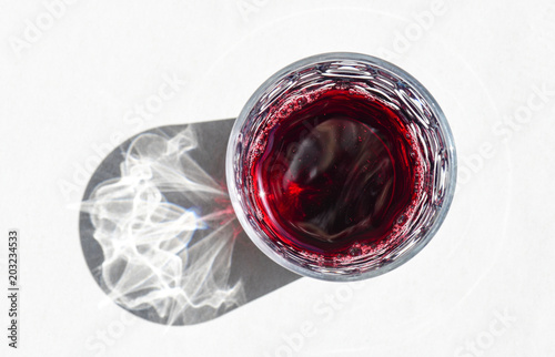 Red wine in glass on white background with shadow