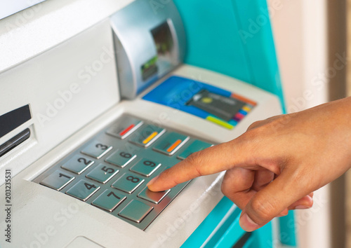 Enter ATM code,Withdrawing money from an ATM,Enter the code on the ATM keyboard,pass code on ATM,press bank matchine keypad photo