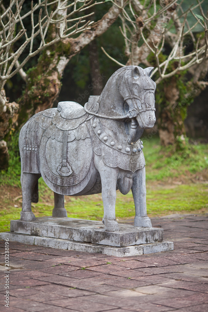 Vietnam, Hue. Stone statue of horse from the royal escort that accompanies the emperor in the other world at Imperial Minh Mang Tomb on the Salutation Court