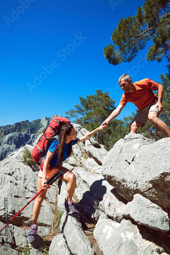 A helping hand high in the mountains in the summer hike