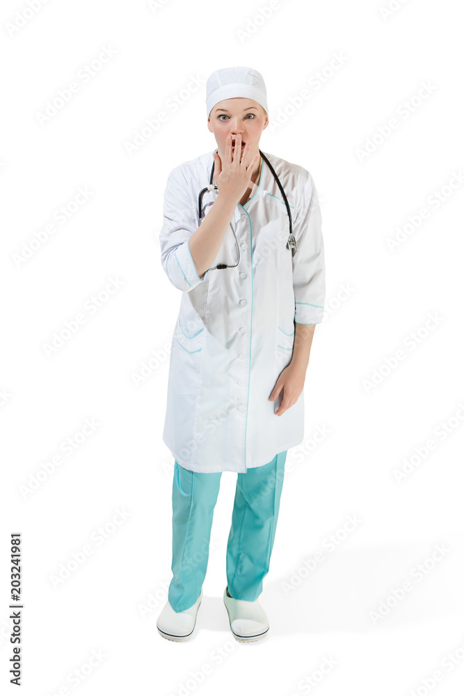 Beautiful young woman is shoked in white coat posing at studio. Full length studio shot isolated on white. Beautiful young woman is shoked in white coat posing at studio. Full length studio shot isolated on white.