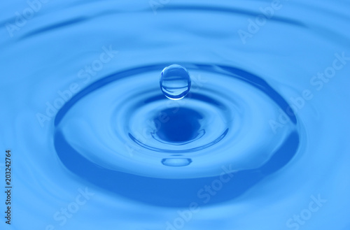 Water drop on a blue surface.