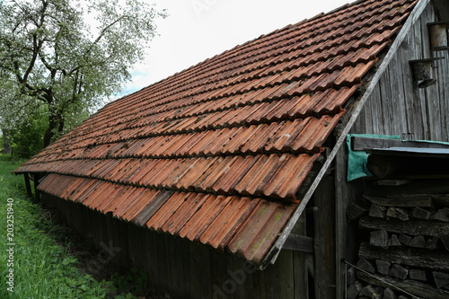 Old tiled roof on a stone house / Details