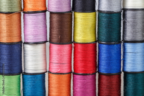 Fototapeta Multi-colored threads for needlework on reels
