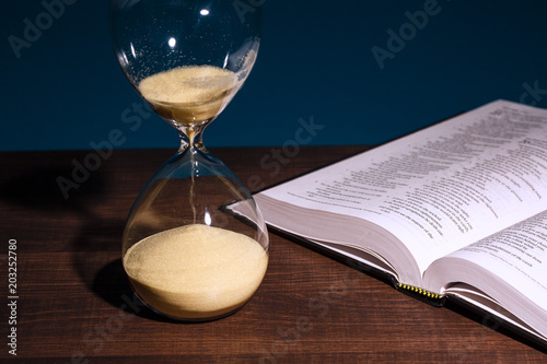 Hourglass and open Bible