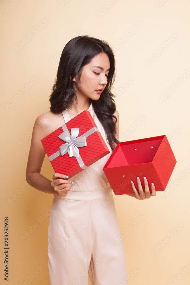 Young Asian woman open a gift box. Young Asian woman open a gift box.