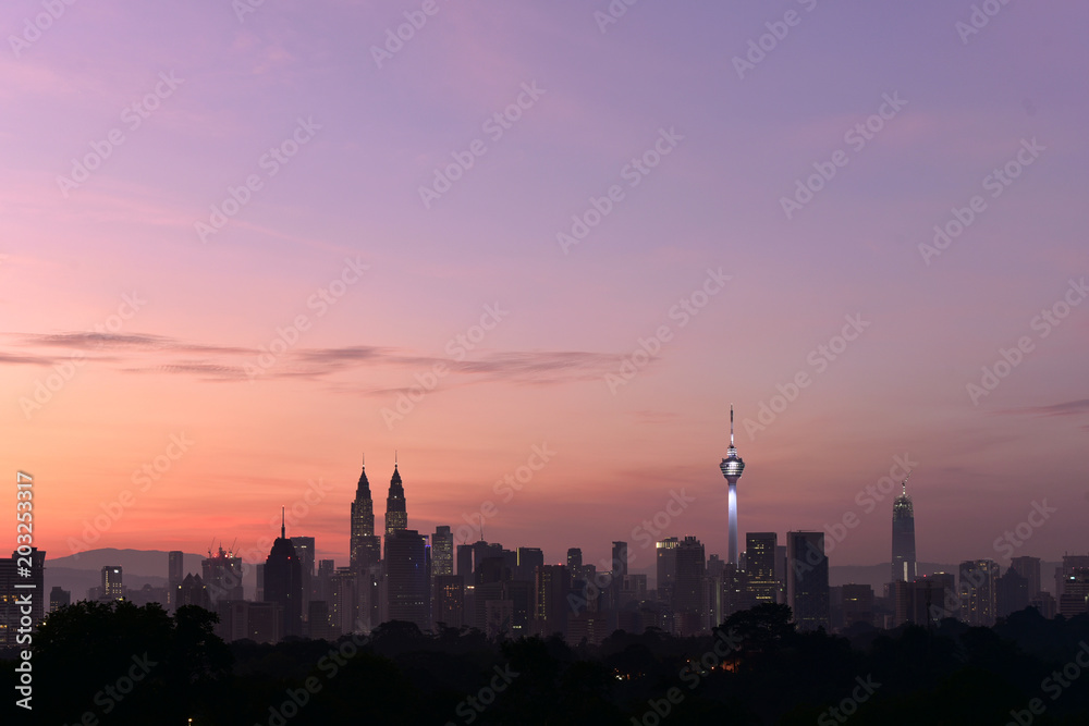 beautiful landscape view of Kuala Lumpur cityscape skyline with sunrise view in dawn and buildings in silhouette