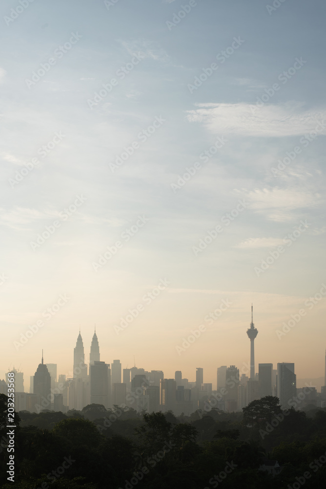 vertical or potrait image of Beautiful Kuala Lumpur cityscape skyline in the morning environment and the buildings in silhouette. tourism and development concept