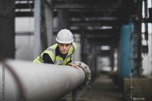 Industrial worker checking pipeline