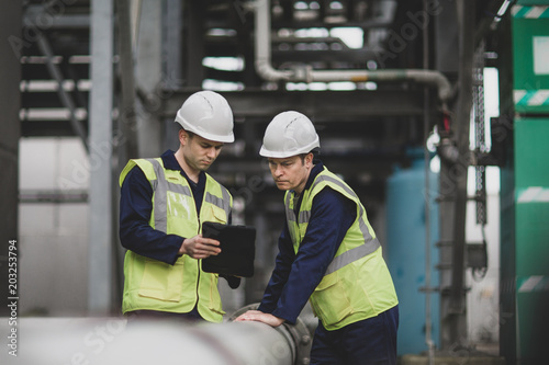 Industrial workers using a digital tablet on site photo