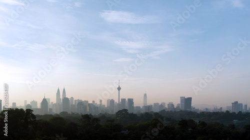 panorama view of beautiful kuala lumpur cityscape skyline in the hazy or foggy morning enviroment and buildings in silhouette with copy space