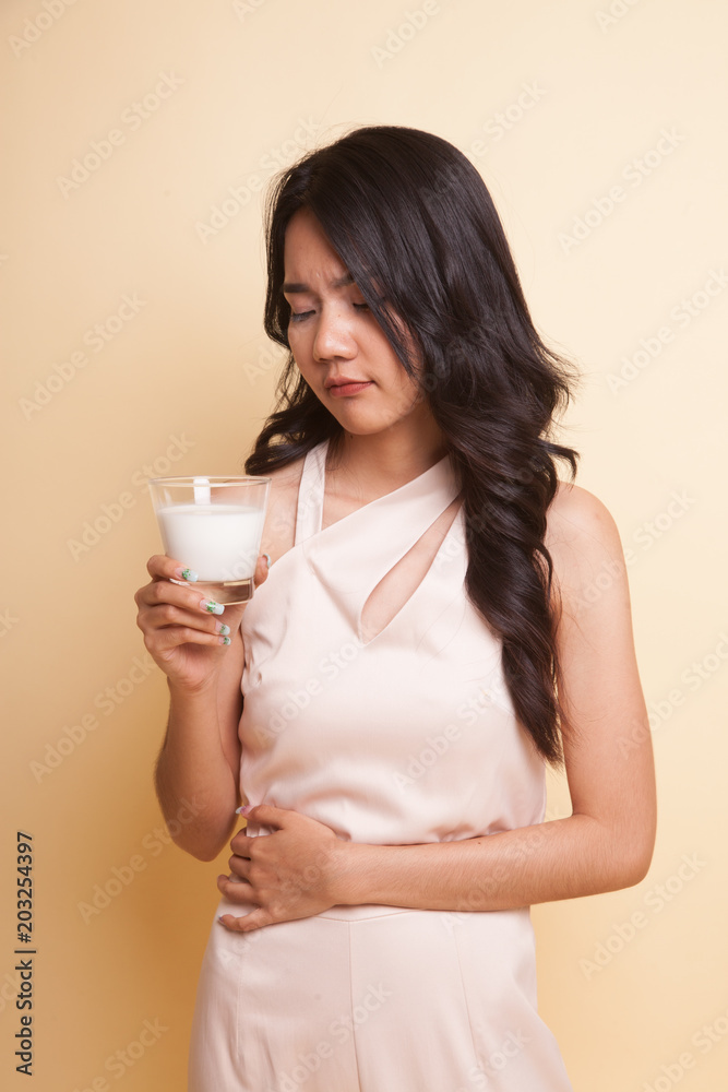 Asian woman drinking a glass of milk got stomachache. Asian woman drinking a glass of milk got stomachache.