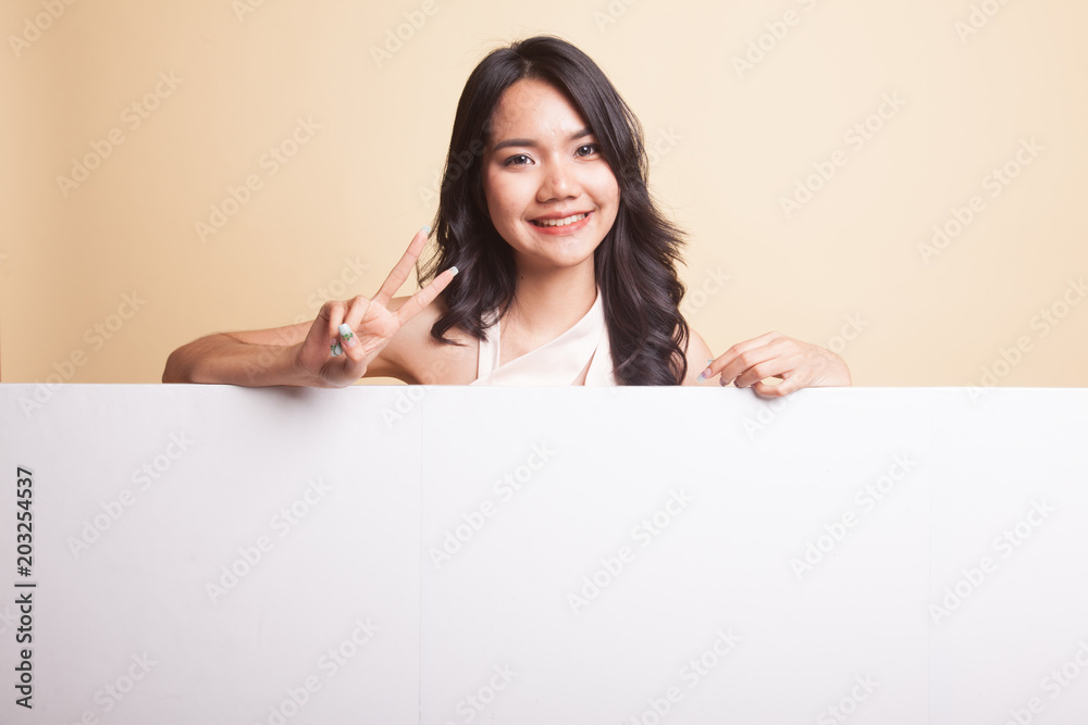 Young Asian woman show victory sign with blank sign. Young Asian woman show victory sign with blank sign.