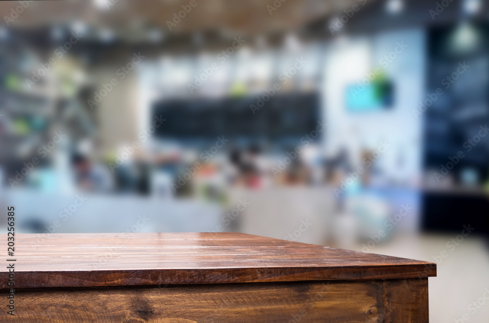 Selected focus empty brown wooden table and Coffee shop or restaurant blur background with bokeh image. for your photomontage or product display. Selected focus empty brown wooden table and Coffee shop or restaurant blur background with bokeh image. for your photomontage or product display.