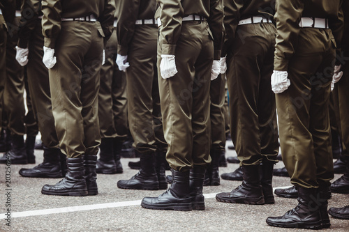 military men in green dress uniform stand at attention
