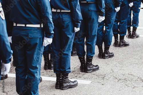 military men in blue dress uniform stand at attention
