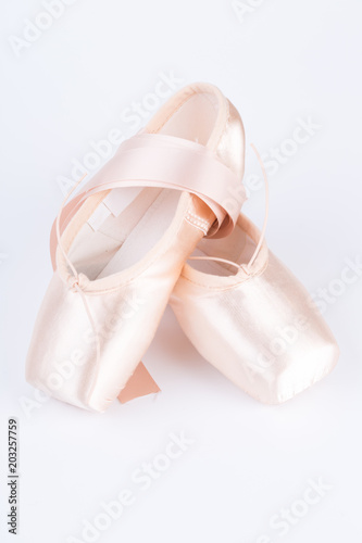 Pink ballet shoes isolated on a white background