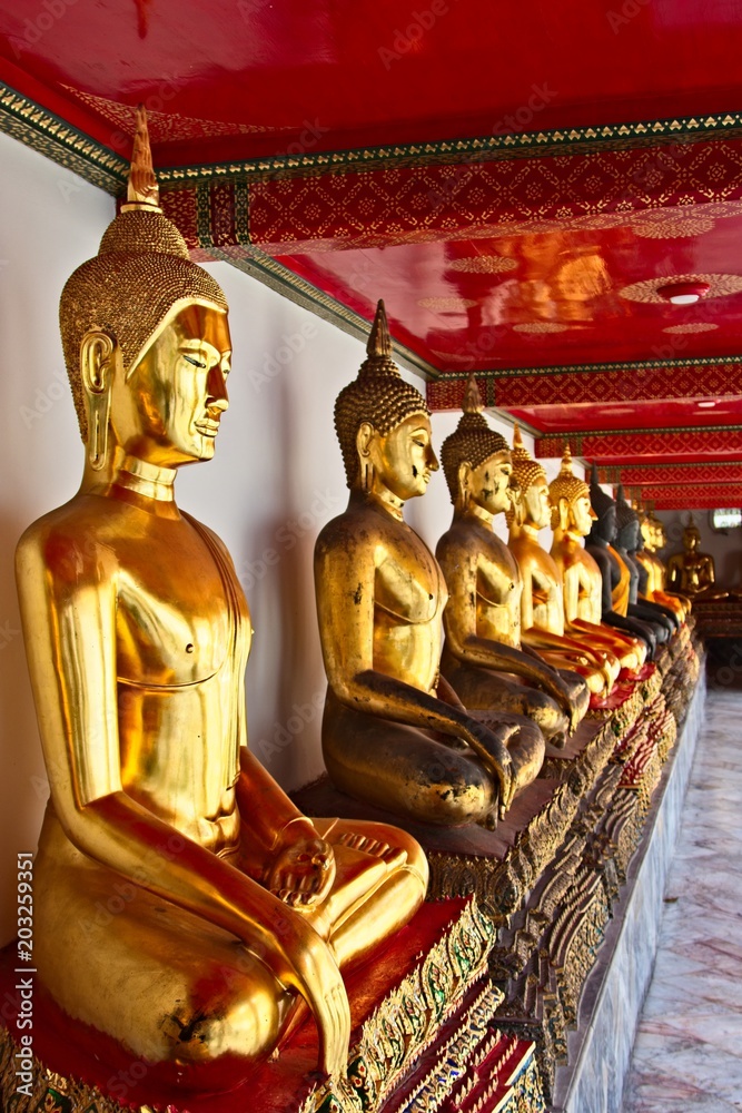 Buddha statues inside the Wat Pho temple in Bangkok, Thailand. This is a popular tourist attraction. 