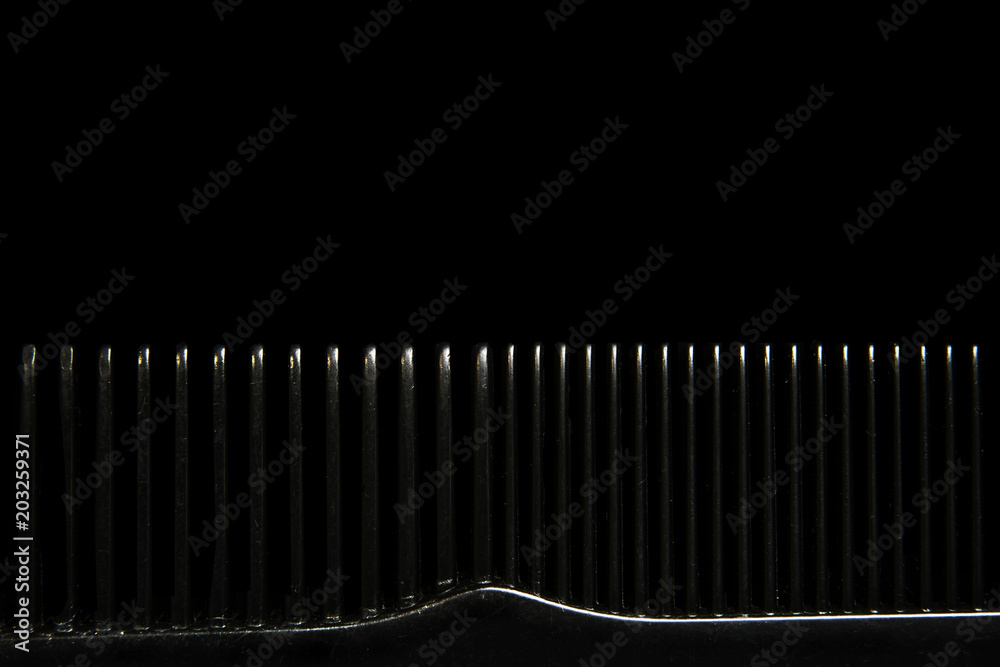 Abstract background with macro comb on black background