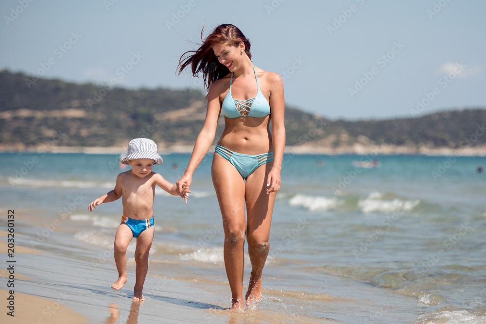 Woman with her son on the beach.
