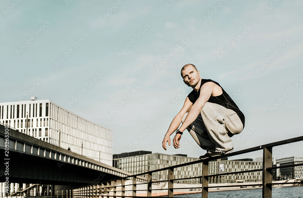 Man sitting on railing