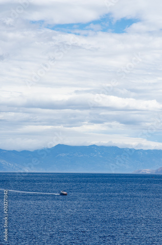 Boat in the sea near mountains © Liz