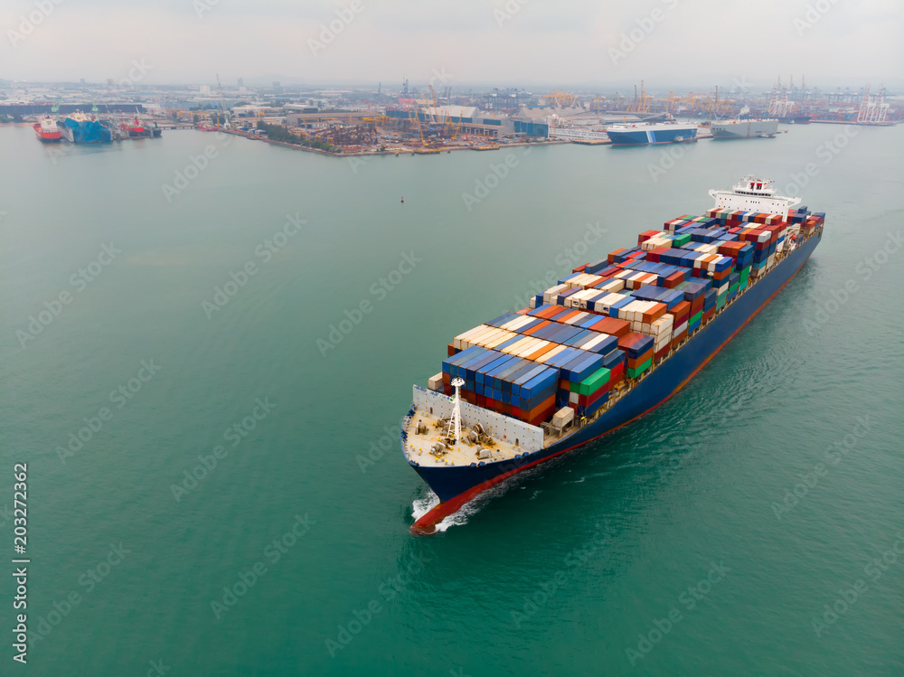 Fototapeta premium Cargo container ship carrying container import and export goods running around container yard port concept freight shipping ship.