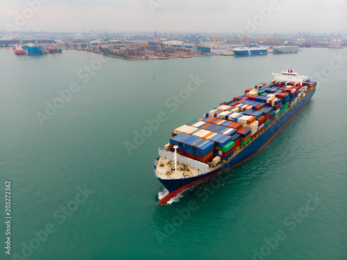 Cargo container ship carrying container import and export goods running around container yard port concept freight shipping ship.