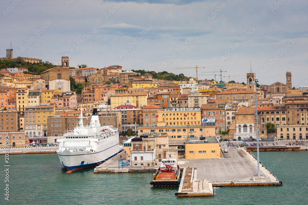 Cityscape of Ancona with ferries at the port viewed from the sea